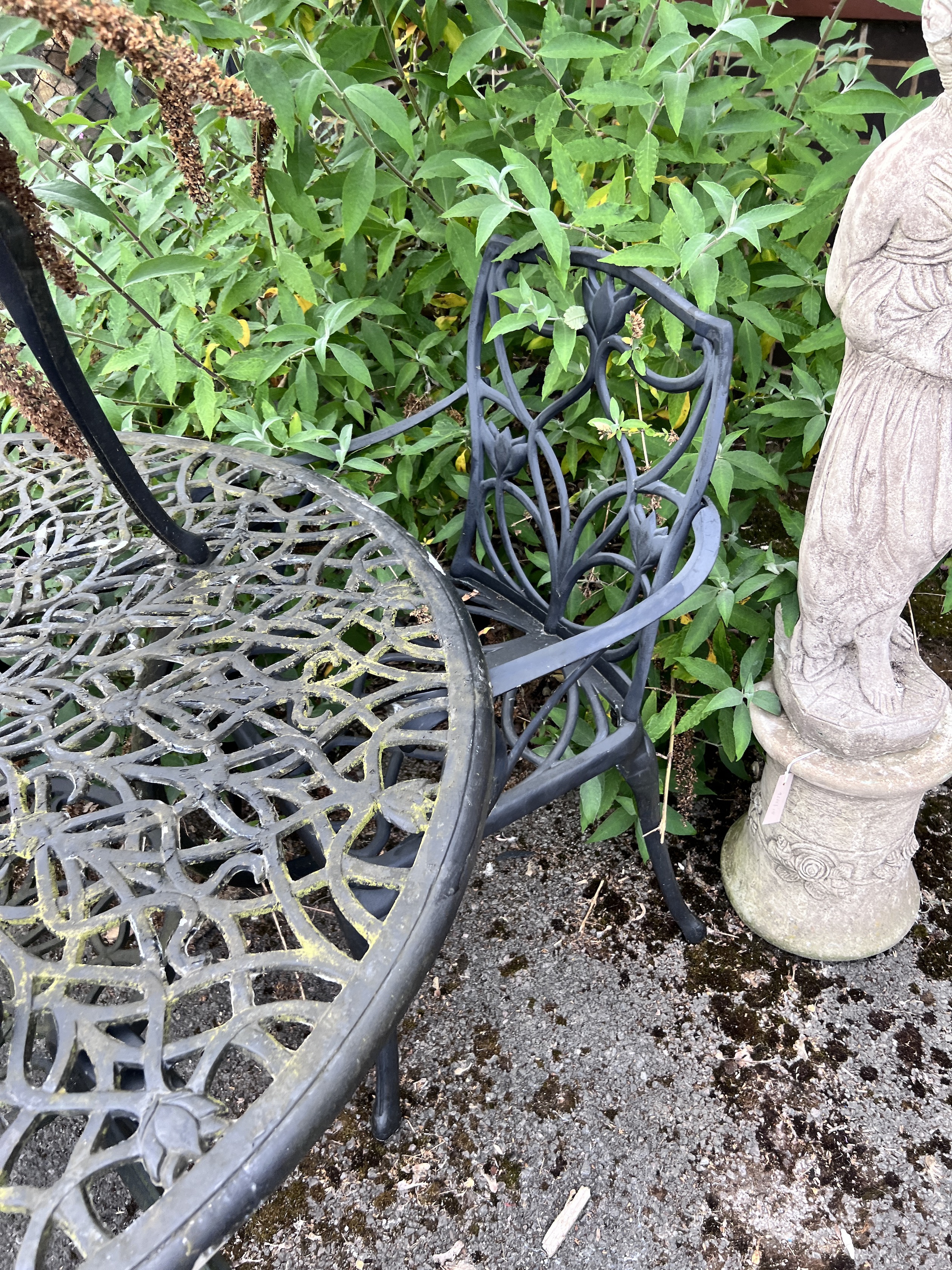 A circular painted aluminium garden table and three chairs, table 120cm diameter, height 72cm